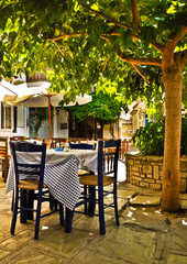 Under tree cafe tables on the village square, Vourliotes, Samos,