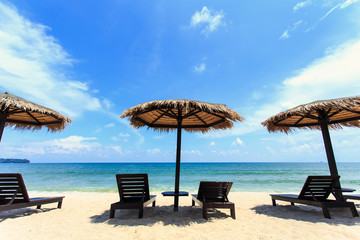 Sun umbrella and sun loungers stand at the beach in Phuket, Thai