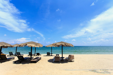 Sun umbrella and sun loungers stand at the beach in Phuket, Thai