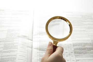 worker examines a magnifying glass text