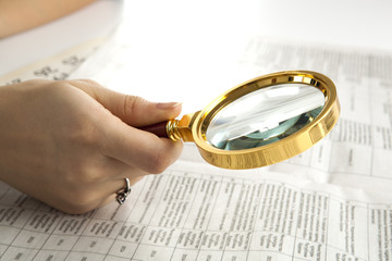 worker examines a magnifying glass text