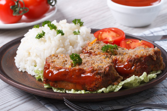 sliced meat loaf with rice and vegetables, horizontal