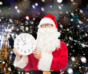 man in costume of santa claus with clock