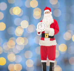 man in costume of santa claus with clock