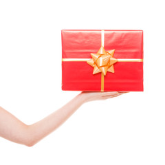 Female hand holding big red gift box isolated