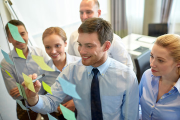 smiling business people with marker and stickers