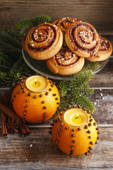 Orange pomander balls with candles and cinnamon rolls