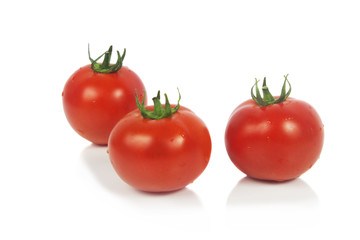 Fresh tomatoes isolated on white