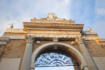 Fototapeta na wymiar Ravenna, medieval city door with Pope symbols.