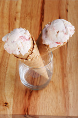 ice cream cone in a  clear glass on wooden background
