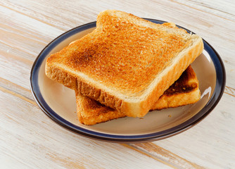 Slices toast bread on wooden background