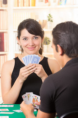 young couple playing cards cuarenta