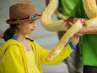 Fototapeta premium Trip to the Zoo - girl and snake at the Zoo