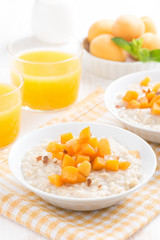 bowl of oatmeal with fresh apricots and orange juice