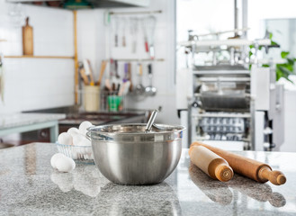 Bowl With Eggs And Rolling Pin In Commercial Kitchen