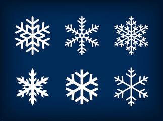 Naklejka premium white snowflakes on dark blue background