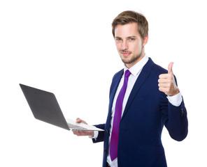 Businessman use of notebook and thumb up