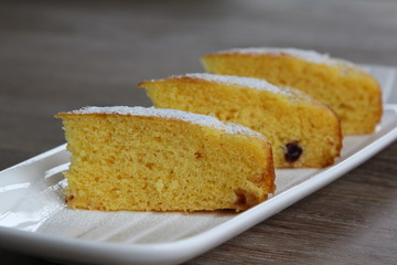 Yellow cake with cranberries topped with icing sugar