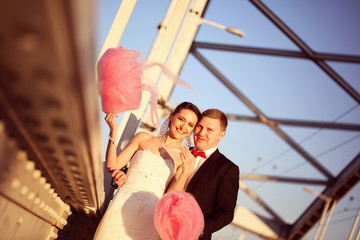 Bride and groom holding a candy floss