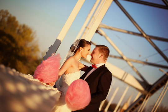 Bride and groom holding a candy floss