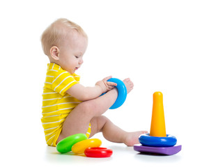funny baby boy playing with colorful toy
