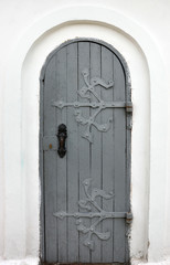 wooden door with wrought iron ornament on it