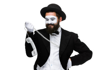 man in the image mime holding a handset.