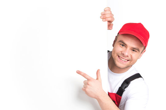 Worker showing blank sign and smiling.