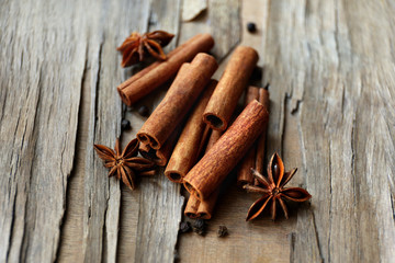 Cinnamon on wooden background, close-up