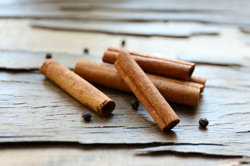 Cinnamon on wooden background, close-up