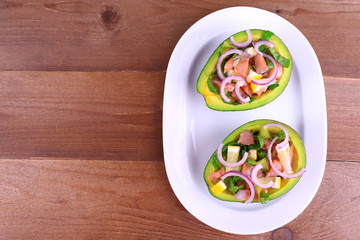 Tasty salad in avocado on plate table close-up