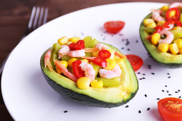 Tasty salad in avocado on plate close-up