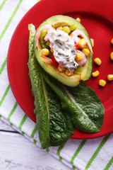 Tasty salad in avocado on plate table close-up