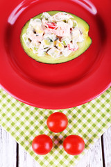 Tasty salad in avocado on plate table close-up