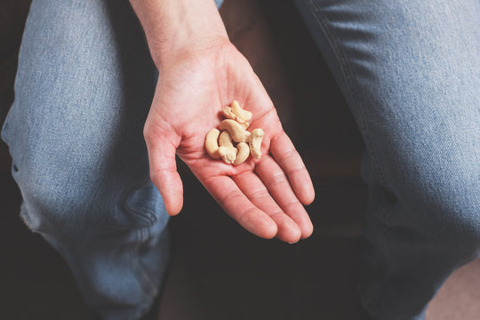 Hand with cashew nuts