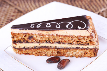 Delicious chocolate cake on plate on table close-up