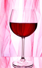 Red wine glass of wine on bright background