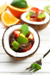 Fruit salad in coconut on table
