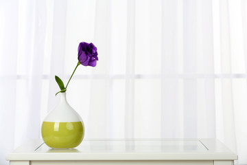 Beautiful bouquet of flowers in vase on window background