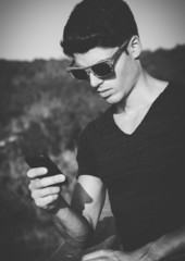 Model man portrait with wooden sunglasses outdoors in a sunny da