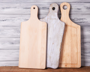 Empty cutting boards on wooden background