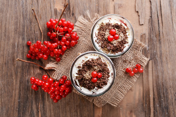 Delicious dessert in jars on table close-up