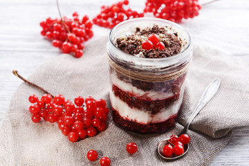 Delicious dessert in jar on table close-up