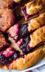 pieces cake with black currant, milk