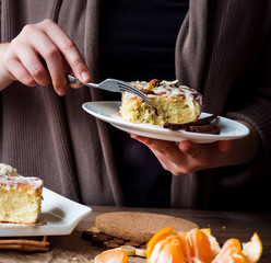 Cinnabon buns with cinnamon, nuts and cream sauce, hands