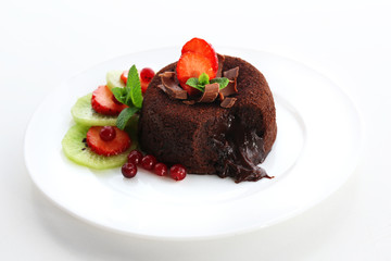 Hot chocolate pudding with fondant centre with fruits, isolated