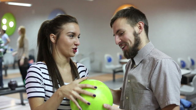 Man and woman talking in the bowling alley