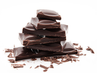 Dark chocolate bars stack with crumbs isolated on a white