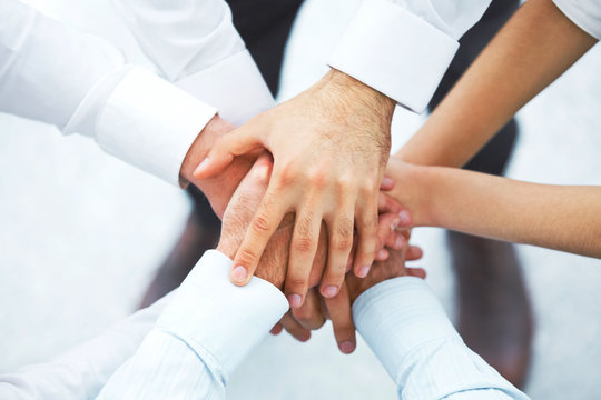 International business team showing unity with their hands toget
