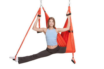 Young woman making aerial yoga exercises in stretching